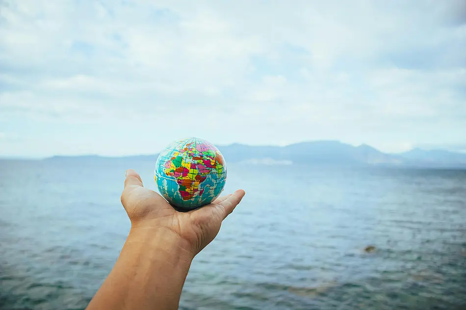 hand holding a globe