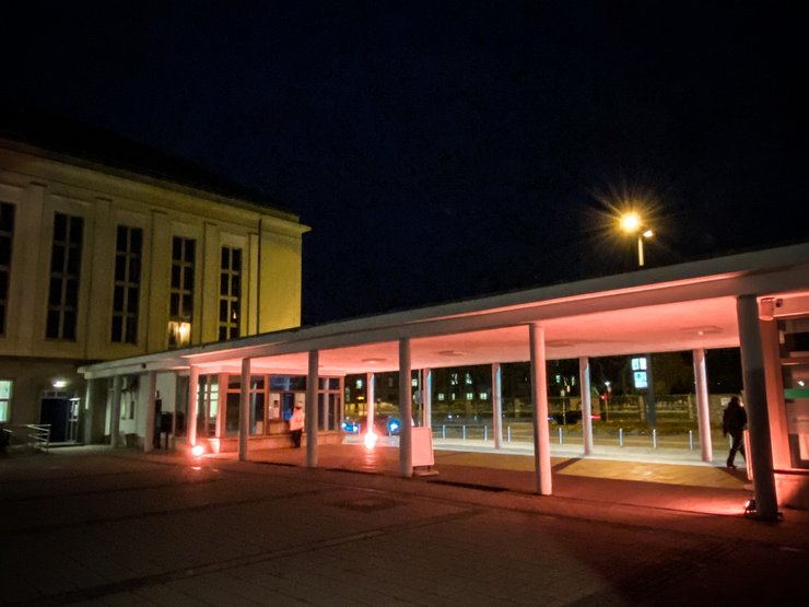 Entrance to the campus of the University of Erfurt illuminated in orange