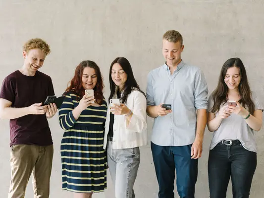 Studierende in Gruppe mit Smartphone