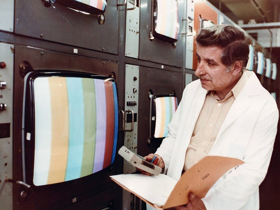 Mann bei der Kontrolle von Farbbildröhren im Werk für Fernsehelektronik