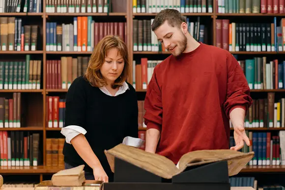 a woman and a man researching in the Gotha Research Library