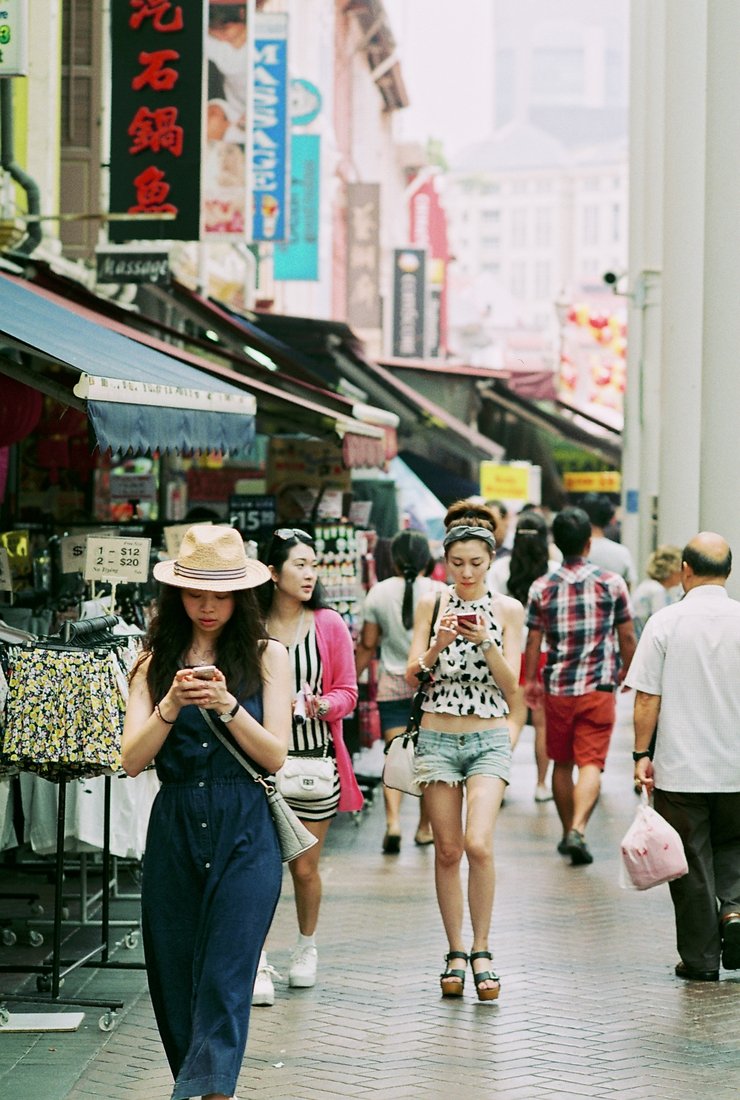Pedestrians with smartphones in Asia