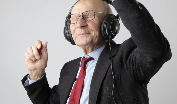 old man in black jacket wearing black headphones
