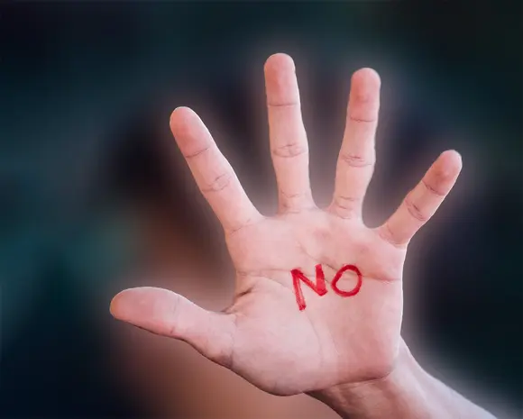Hand on which "No" is written
