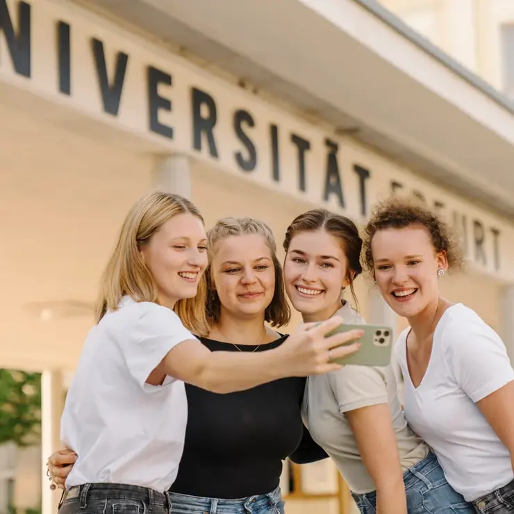 Female students in front of the main entrance