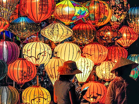 two-person-standing-near-assorted-color-paper-lanterns_photo by min an from pexels