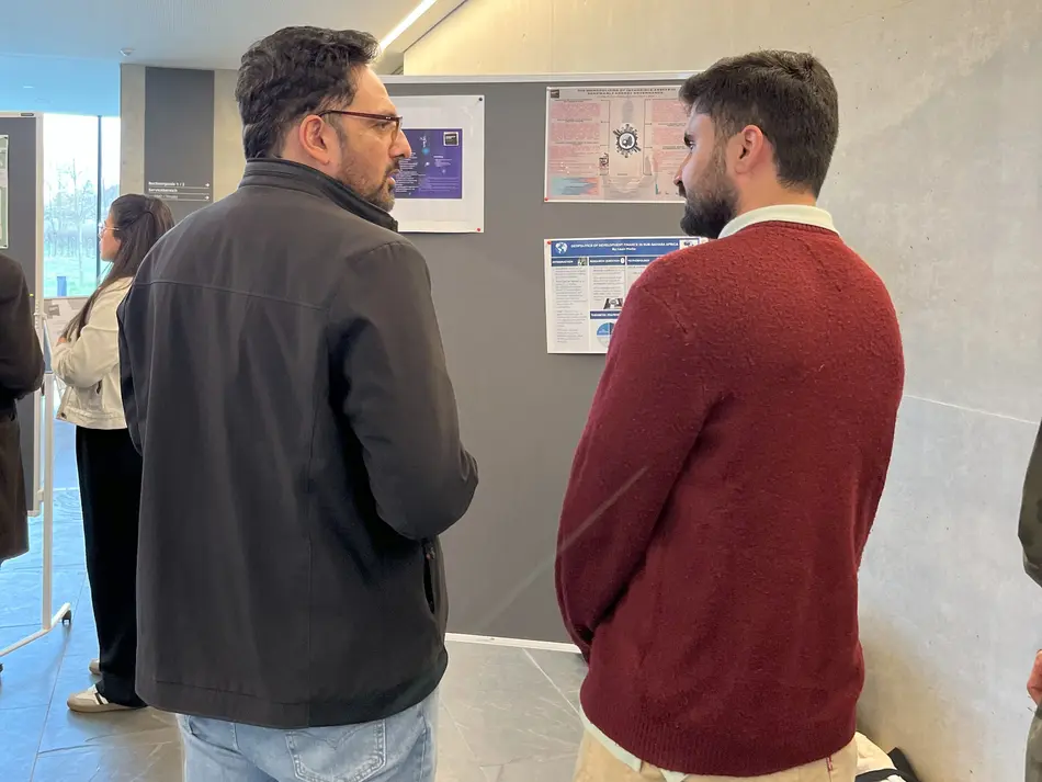 Dr. Hasnain Bokhari and MPP student Waseem in discussion about the posters