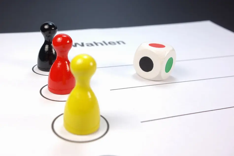 symbolic ballot paper with dice and game pieces
