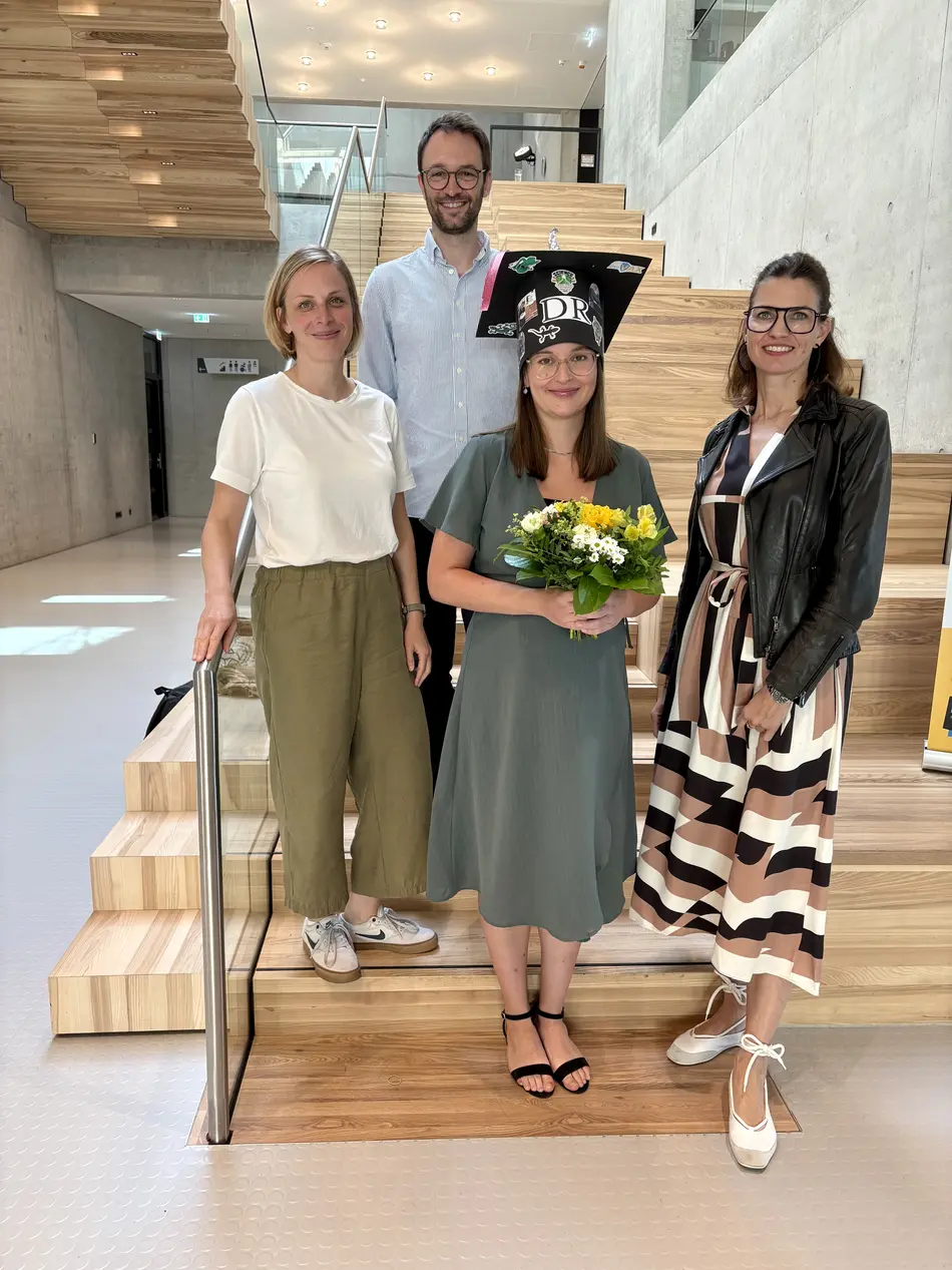 4 people on a wooden staircase