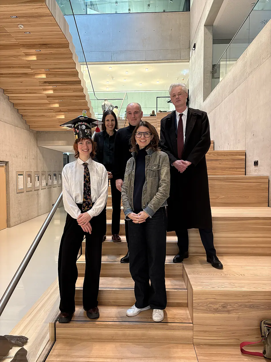 Five people on a wooden staircase
