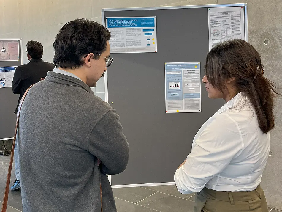 MPP students discussing the posters and thesis projects