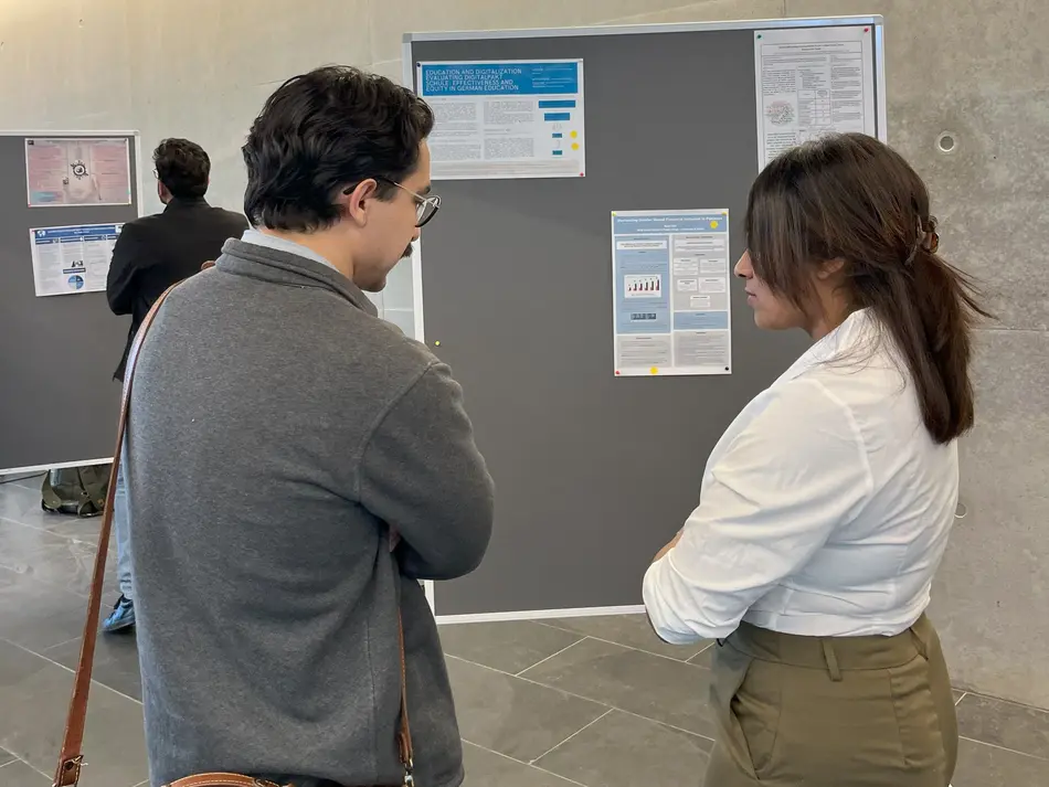 MPP students discussing the posters and thesis projects