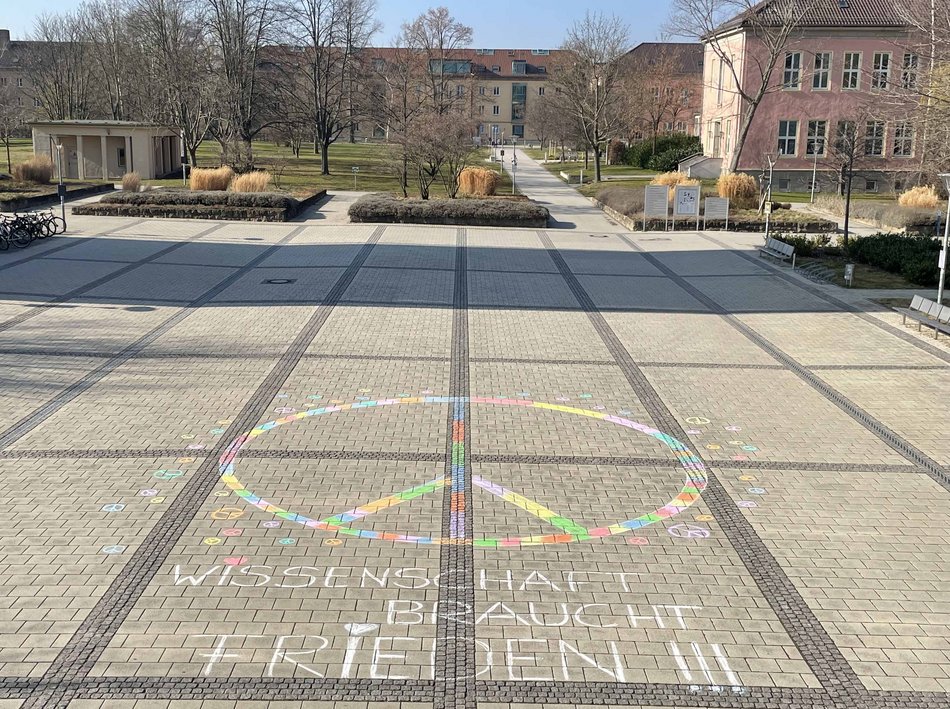 peace sign with street chalk at the entrance to the University of Erfurt