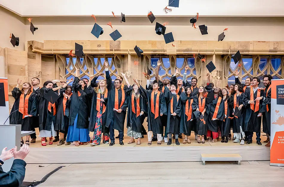 students throwing caps
