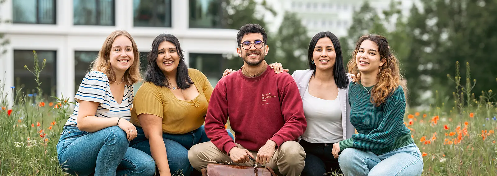 students sitting on a lawn